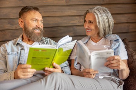 Photo for Love reading. Man and woman reading books and looking interested and relaxed - Royalty Free Image