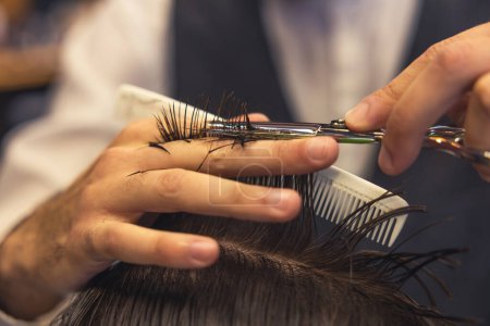 Photo for New haircut. Close up of hairdressers hands cutting hair - Royalty Free Image