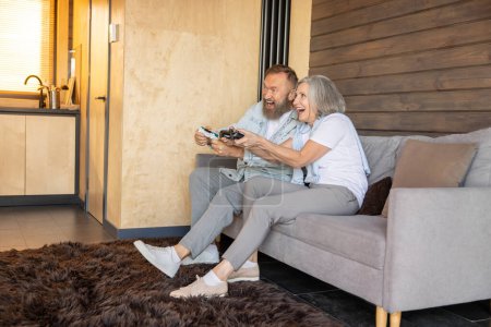 Photo for Video games. Mature couple playing video games and looking excited - Royalty Free Image