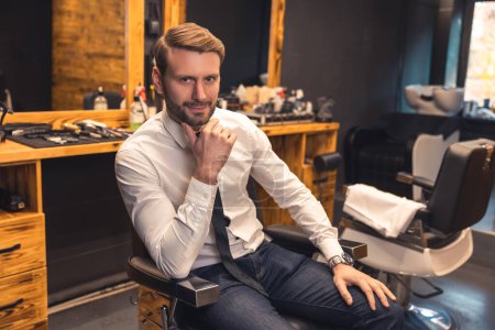 Photo for Elegant man. Good-looking confident businessman in a barbershop - Royalty Free Image