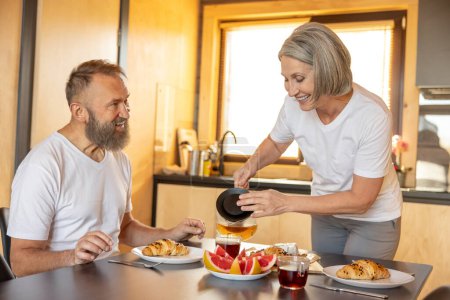 Photo for Breakfast time. Happy couple having breakfast and feeling comfortable - Royalty Free Image