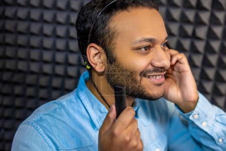 Foto de Hearing checkup. Smiling young man having a hearing checkup - Imagen libre de derechos