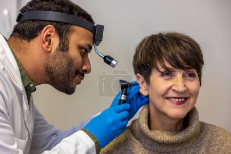 Téléchargez les photos : Checkup. ENT doctor examinine patients ear with endoscope - en image libre de droit
