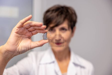 Photo for Hearing aid. Two ent doctors demonstrating innovative hearing aids - Royalty Free Image