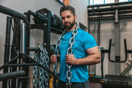 Photo for Heavy weights. Sportsman working with heavy weights in a gym - Royalty Free Image