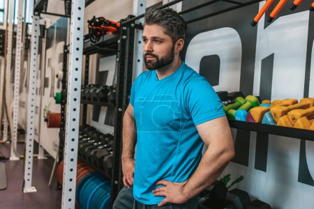 Photo for After workout. Man in blue tshirt having rest after a workout - Royalty Free Image