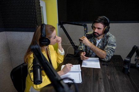 Photo for Dialog. Radio dj talking to a young singer at the radio station - Royalty Free Image