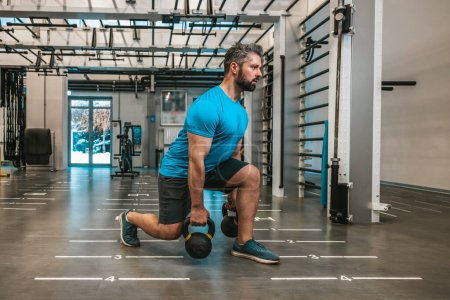 Photo for Workout. Young bearded man having a workout in gym - Royalty Free Image