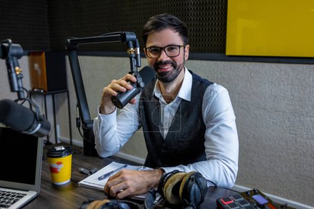 Photo for At the radio studio. Bearded dark-haired man looking at the camera - Royalty Free Image