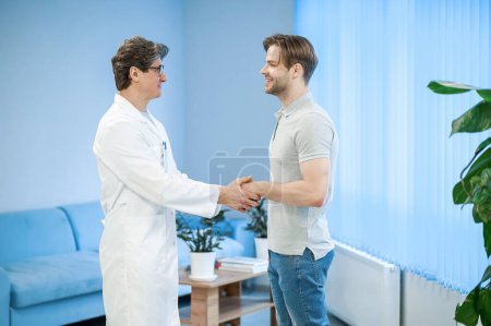 Photo for Doctor and patient. Doctor greeting a patient and they looking contented - Royalty Free Image