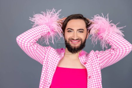 Photo for Cheerful smiling transgender person wearing pink clothing posing having fun on party laughing happily isolated over gray background - Royalty Free Image