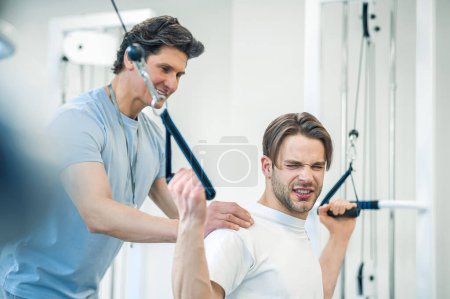 Photo for Healthcare. Man having a workout on hyperextension - Royalty Free Image