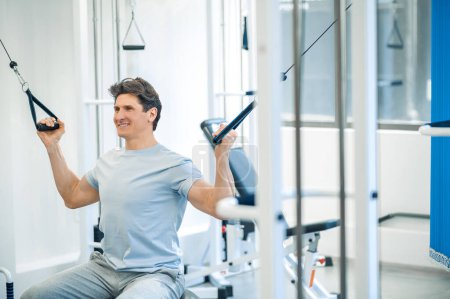 Photo for Healthcare. Man having a workout on hyperextension - Royalty Free Image