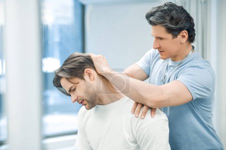 Photo for Neck rehabilitation. Physical therapist working with patients neck - Royalty Free Image