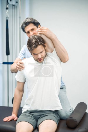 Photo for Neck rehabilitation. Physical therapist working with patients neck - Royalty Free Image