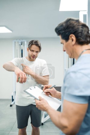 Photo for Physical therapy. Male patient have a physical therapy session in rehabilitation center - Royalty Free Image