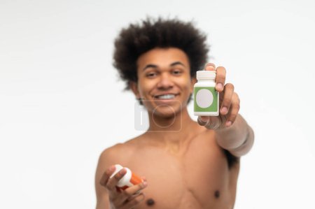 Foto de Estilo de vida saludable. Joven afroamericano eligiendo vitaminas para su salud - Imagen libre de derechos