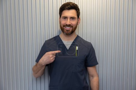 Photo for In dentistry. Bearded dentist posing with a toothbrush - Royalty Free Image