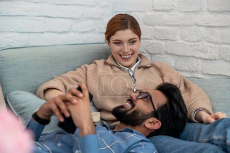 Photo for Happy couple. Happy couple spending time at home and looking contented - Royalty Free Image