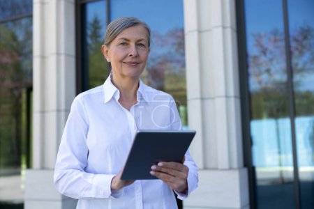 Photo for Business owner. Business woman in white blouse with a laptop in hands - Royalty Free Image