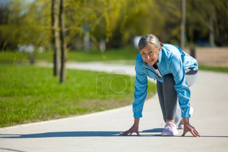 Photo for Run. Woman in blue sportswear getting ready for a run - Royalty Free Image