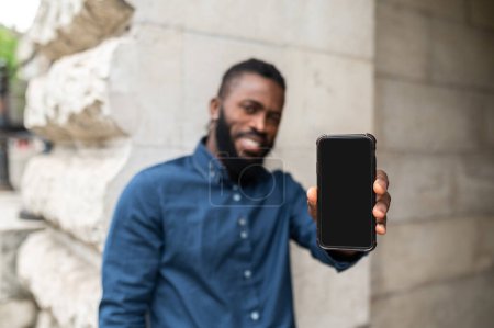 Photo for New phone. Bearded young dark-skinned man with a phone - Royalty Free Image