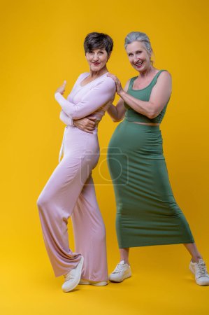 Photo for Femininity. Two good-looking senior women feeling excited - Royalty Free Image