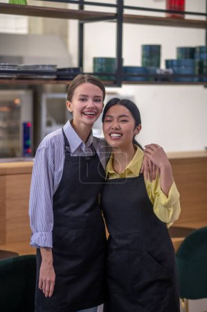 Photo for Colleagues. Cute female colleagues at the working place at the cafe - Royalty Free Image