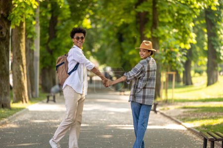 Photo for Excited. A couple walking in the park and looking excited and enjoyed - Royalty Free Image