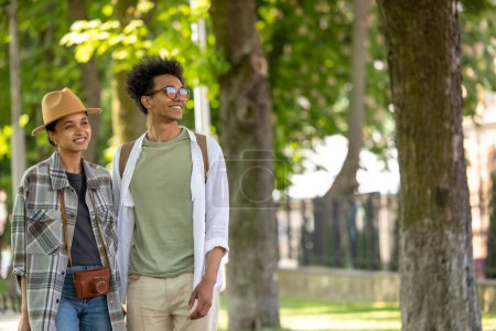 Téléchargez les photos : La liberté. Deux jeunes gens marchant dans le parc et regardant insouciant - en image libre de droit