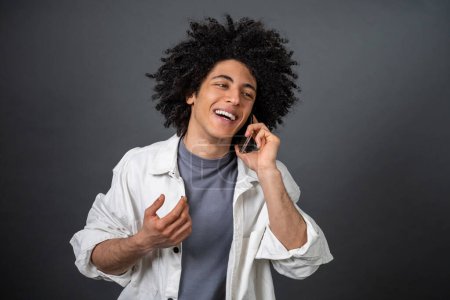 Photo for Phone call. Man in white shirt talking on the phone and smiling - Royalty Free Image