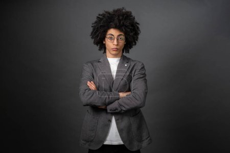 Photo for Determined. Curly-haired young businessman standing with his arms crossed - Royalty Free Image