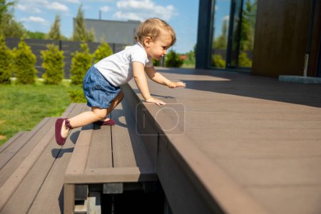 Photo for First steps. Cute little fair-haired kid on the steps - Royalty Free Image
