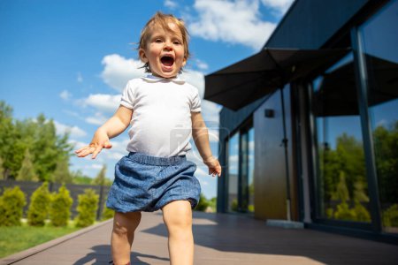 Photo for First steps. Smiling cute kid walking and looking excited - Royalty Free Image