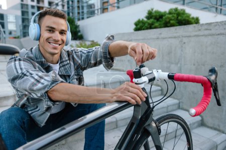 Photo for Bike repair. Smiling young man fixing a problem with the bike - Royalty Free Image