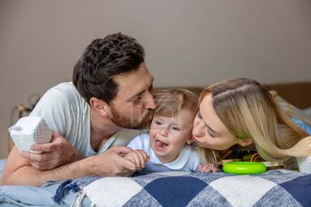 Photo for Happiness. Smiling cute family on the bed looking contented - Royalty Free Image
