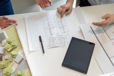 Photo for Unrecognizable designer hands working on blueprint design on table with digital tablet and sketches in office. - Royalty Free Image