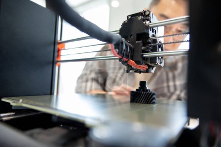 Photo for Closeup of man checking 3d printer, process of making things on 3d printer in laboratory. - Royalty Free Image