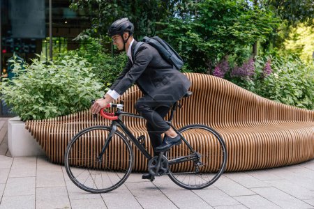 Photo for Eco transport. Young manager commuting to the office on a bike - Royalty Free Image