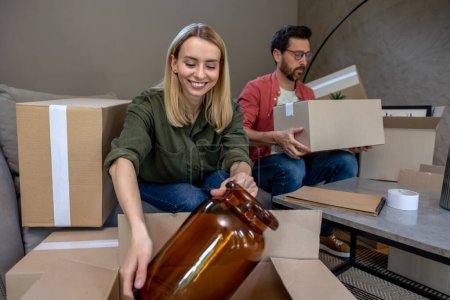 Photo for Packing. Young family looking involved while packing boxes for the move - Royalty Free Image