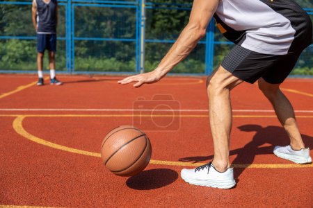 Photo for Two street basketball players playing hard on court. - Royalty Free Image