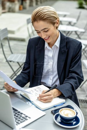 Photo for Working day. Young blonde manager making notes and looking concentrated - Royalty Free Image