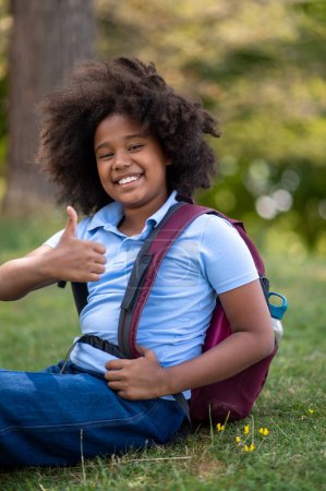 Photo for Happy girl. Curly-haired cute smiling dark-skinned girl in the park - Royalty Free Image