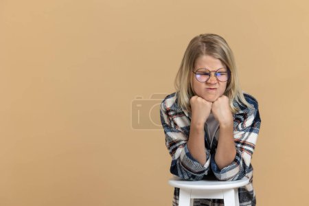 Photo for Feeling bored. Teen girl in eyeglasses looking unhappy and bored - Royalty Free Image