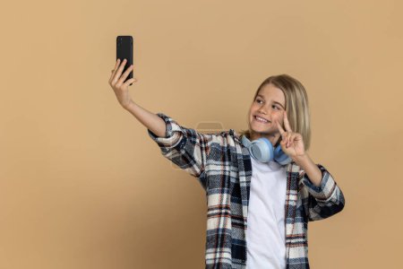 Téléchargez les photos : Selfie. sourire adolescent fille faire selfie et regarder apprécié - en image libre de droit