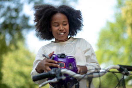 Photo for Leisure. Cute african american girl riding a park - Royalty Free Image