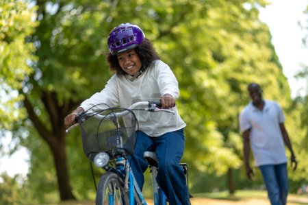 Photo for Ride in a park. Cute family riding bikes in a park - Royalty Free Image
