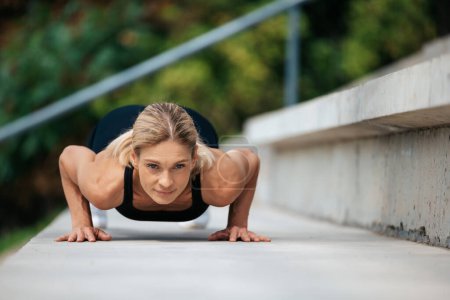 Photo for Active lifestyle. Muscular strength. Active outdoors. Blonde woman doing push ups outdoor. - Royalty Free Image