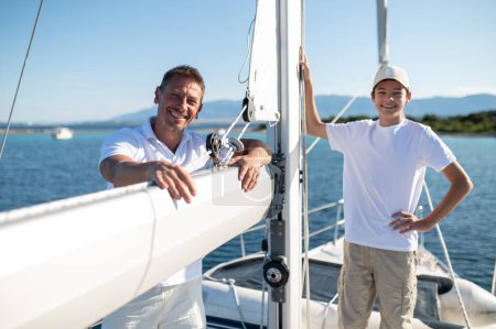 Photo for Happy family. Father and son sailing and looking happy and joyful - Royalty Free Image