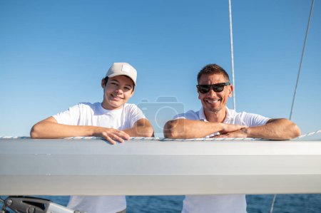 Photo for Happy family. Father and son sailing and looking happy and joyful - Royalty Free Image